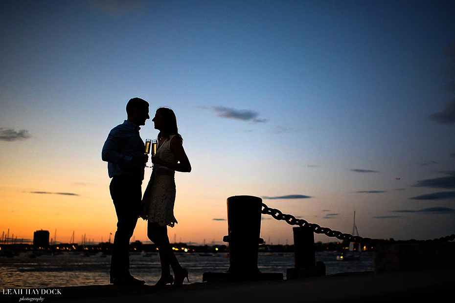 Boston Waterfront Engagement Pictures. Silhouette of engaged couple at sunset on Boston waterfront. 